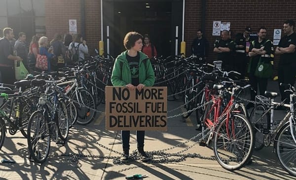 Climate activists chain bikes across grocery store entrances to block gas truck deliveries